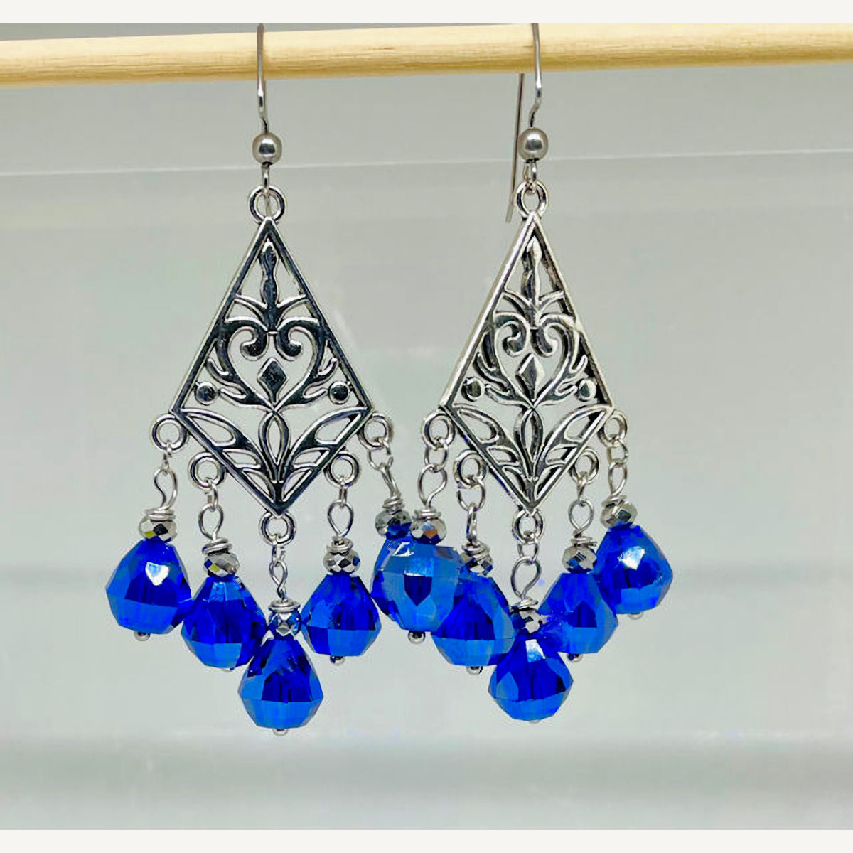 Filigree dangling earrings with Faceted Royal Blue Teardrop crystals