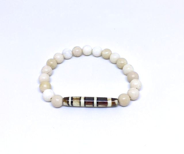 Antiqued Bone Stretch Bracelet Accented with a Carved Tribal Bead