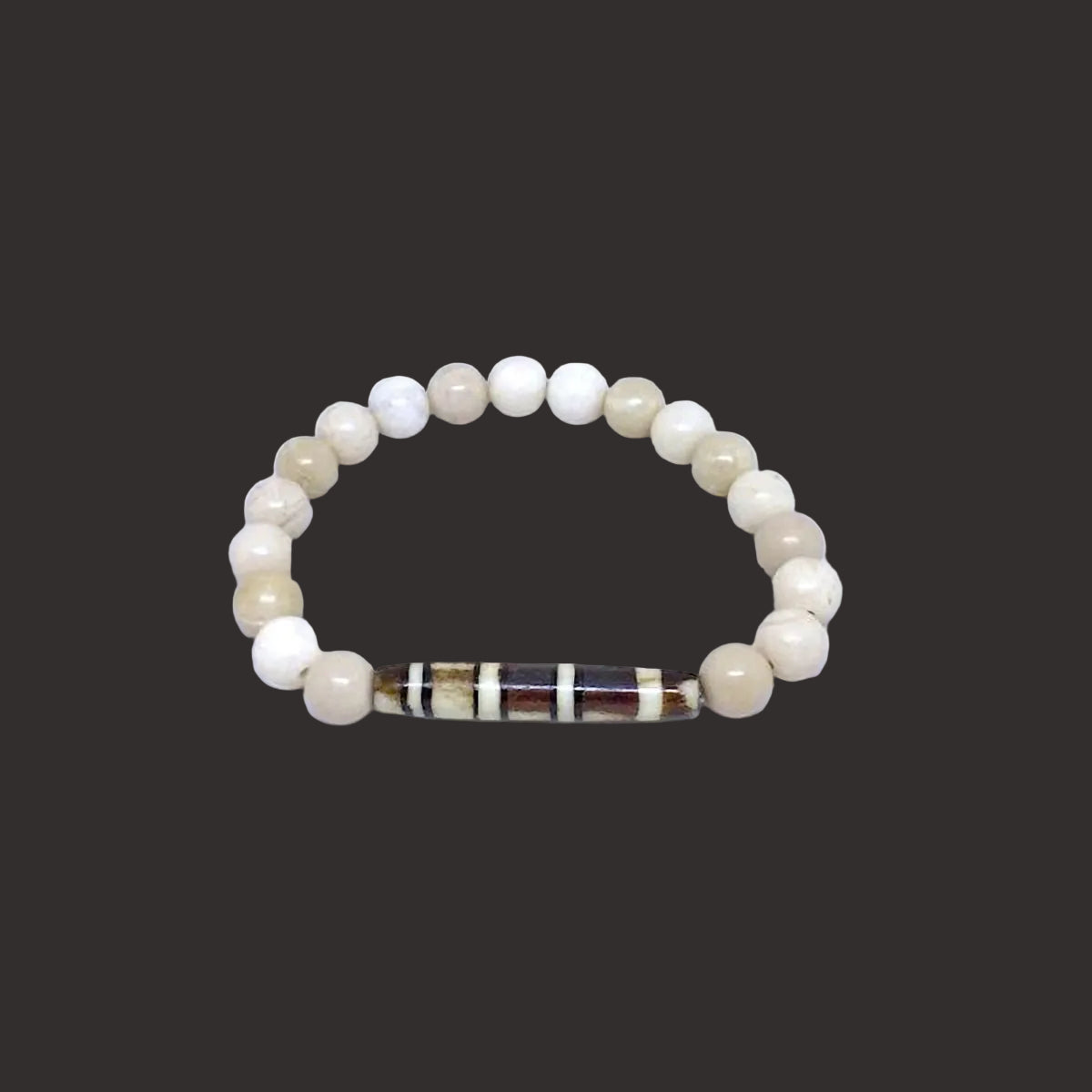 Antiqued Bone Stretch Bracelet Accented with a Carved Tribal Bead
