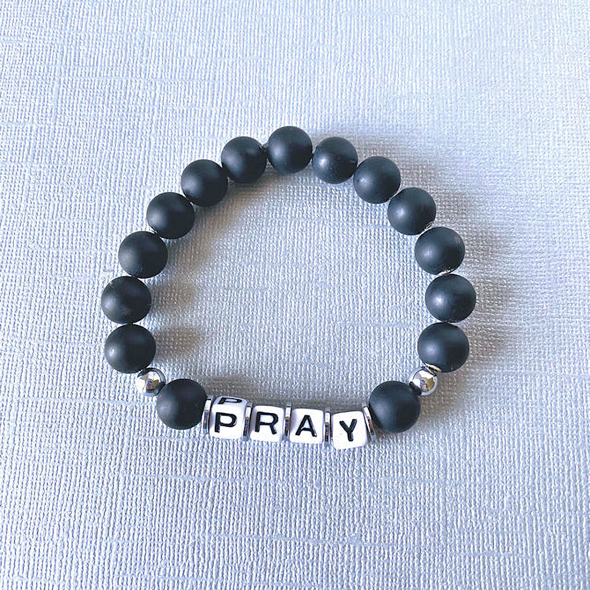 Spiritual Resonance: Matte Black Onyx Stretch Bracelet with 'PRAY' Inspiration