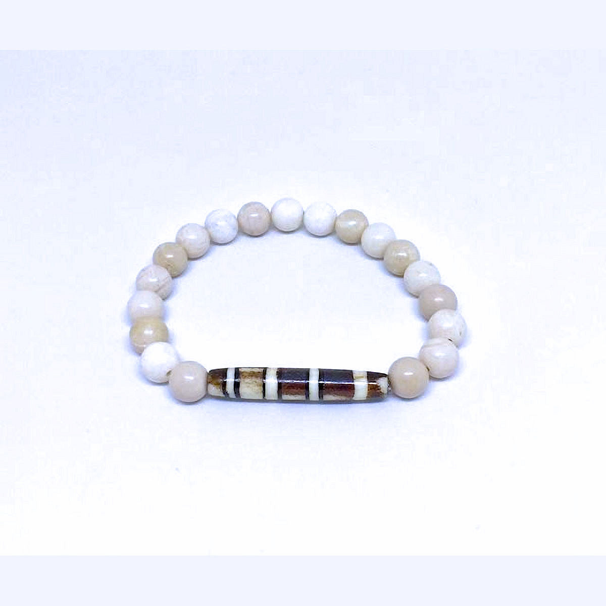 Antiqued Bone Stretch Bracelet Accented with a Carved Tribal Bead