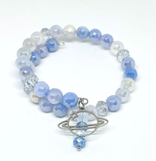 Faceted light blue, white, and clear beaded memory wire wrap bracelet with Saturn charm